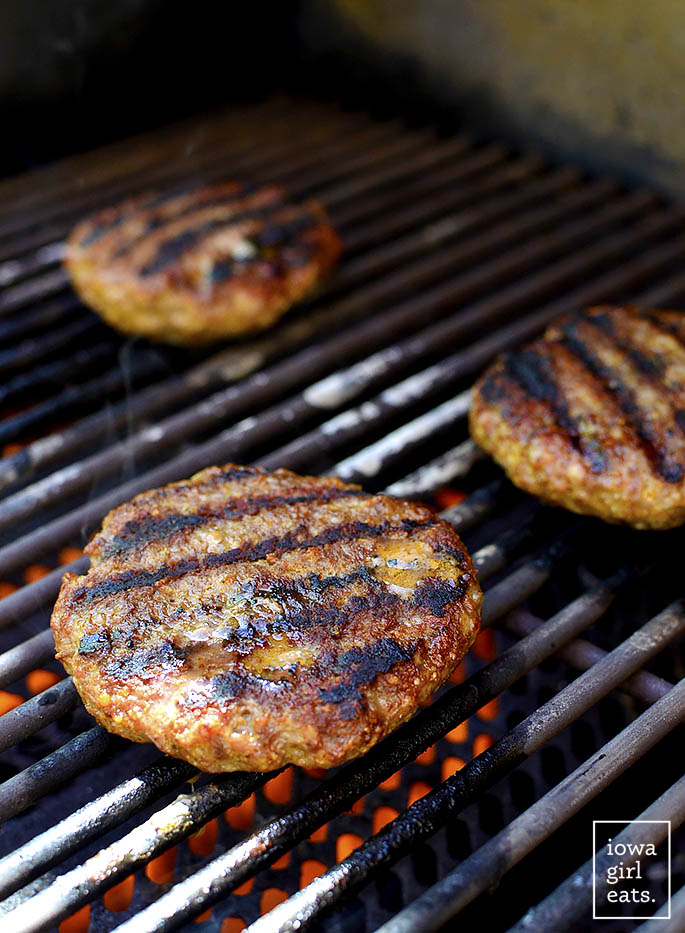 Homemade Brat Burgers with Gluten-Free Beer-Braised Caramelized Onions are homemade brat patties (just pork and spices,) topped with luscious, gluten-free beer-spiked onions. You'll be making this easy grilling recipe all summer long! | iowagirleats.com