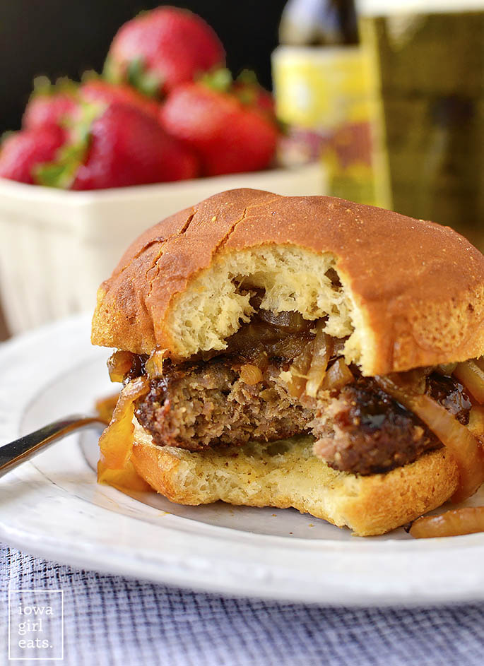 Homemade Brat Burgers with Gluten-Free Beer-Braised Caramelized Onions are homemade brat patties (just pork and spices,) topped with luscious, gluten-free beer-spiked onions. You'll be making this easy grilling recipe all summer long! | iowagirleats.com
