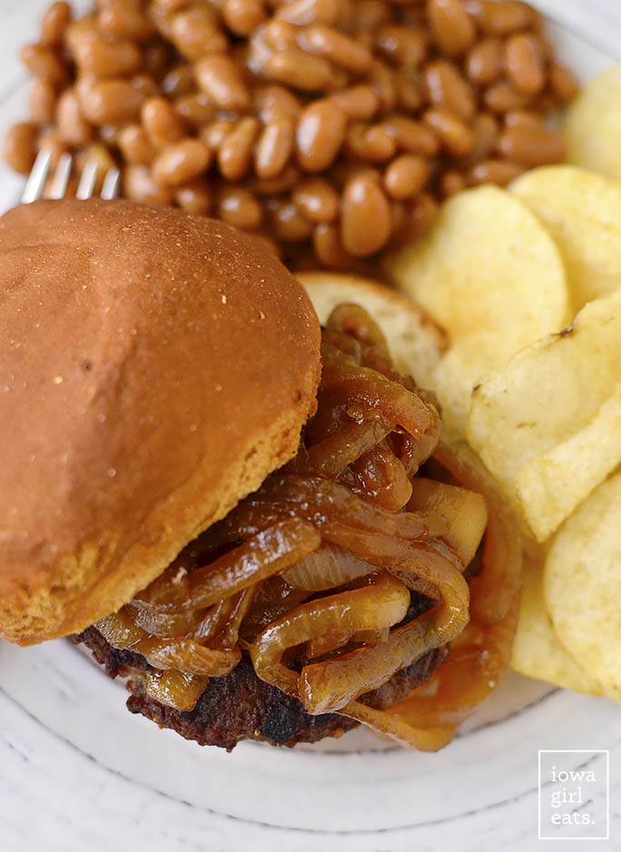 Homemade Brat Burgers with Gluten-Free Beer-Braised Caramelized Onions are homemade brat patties (just pork and spices,) topped with luscious, gluten-free beer-spiked onions. You'll be making this easy grilling recipe all summer long! | iowagirleats.com